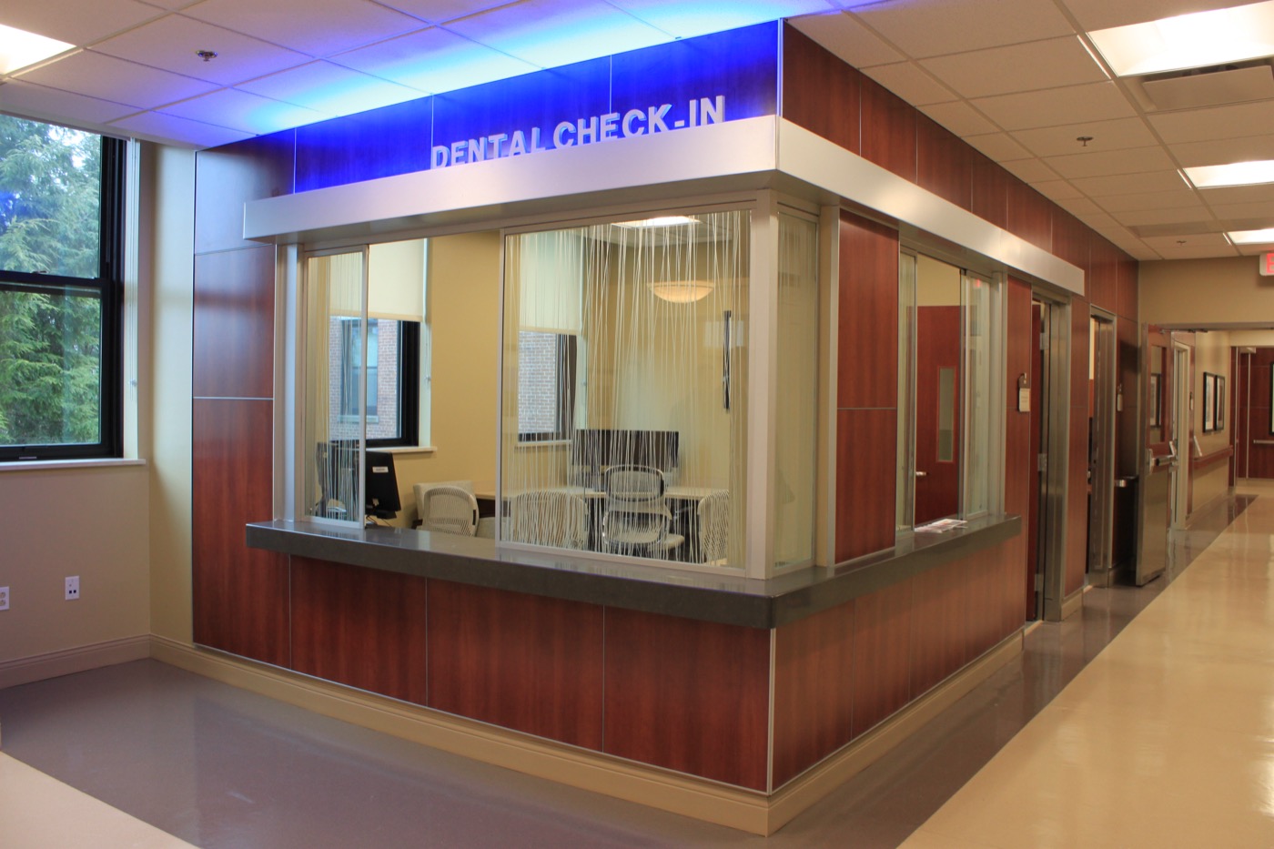 Dental clinic entry vestibule with wood paneling